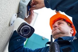 man installing a cctv camera