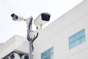 surveillance security camera video equipment on pole outdoor building safety system area control and copy space