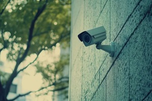 modern surveillance camera mounted on a textured wall